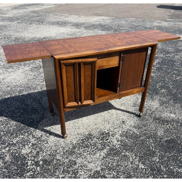 Thomasville Urbana mid century rolling server/bar cart in great condition with a refinished top. Both sides have a...