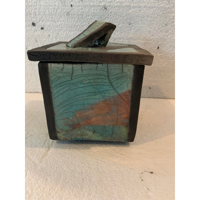 Glazed ceramic box rectangular box with removable lid green background with black rim signed by the artist "j gallart"...