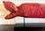 Red reclining Buddhas symbolize the historical Buddha's final moments of earthly life as he enters Parinirvana—the state...