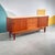 Beautiful 75” Danish modern Teak credenza. 2 sliding doors concealing 1 shelf wonderfully finished compartments centered...