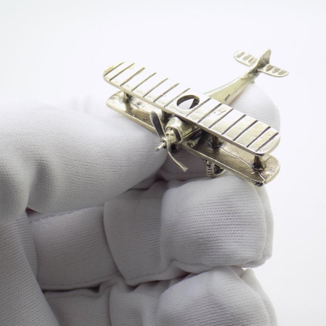 A vintage object depicting a miniature airplane, crafted in Italy between the 1980s and 1990s in authentic continental...