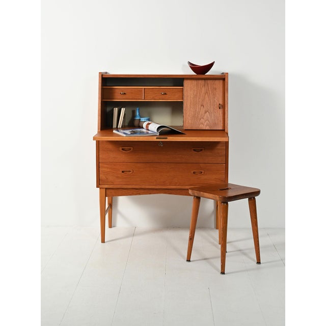 Slender, geometric lines, three drawers, and a drop-leaf door. Interior features a brass card holder, small drawers, and a...