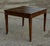 Square table with spiked stems plated in italian walnut from the early 1800s. The drawer is missing and the top has a...