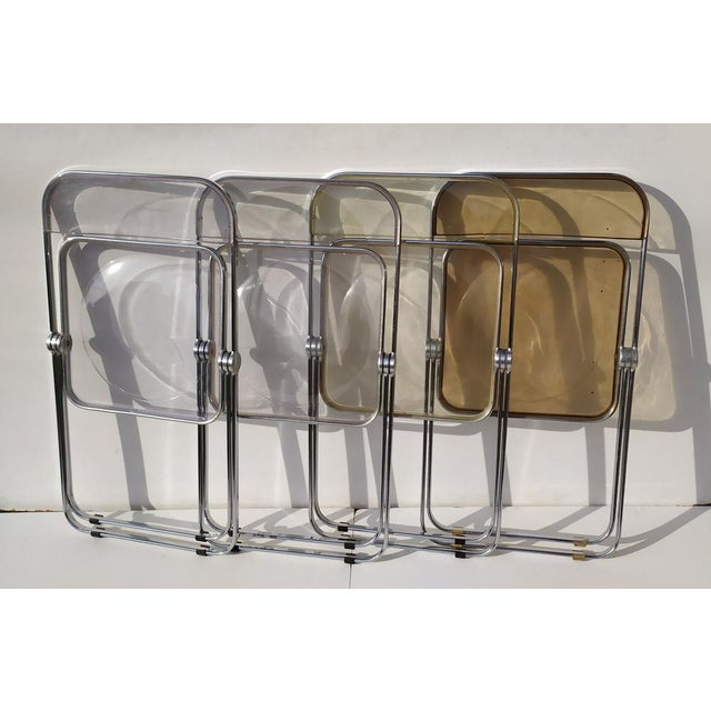 N.4 Plia chairs made by Kartell. Designer Anna Maria Castelli. N. 4 different colors: transparent, brown, yellow, azur....