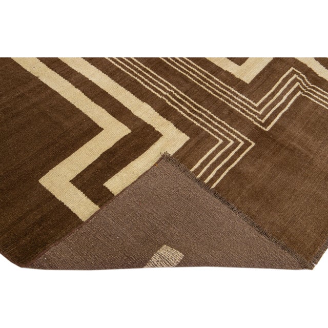 This Beautiful Modern Art Deco handmade wool rug makes part of our Northwest collection and features a brown color field...