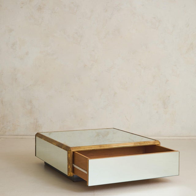 Sourced in Paris, this mirror coffee table with brass detailing from the 1970s, is an exercise in restraint and precision,...