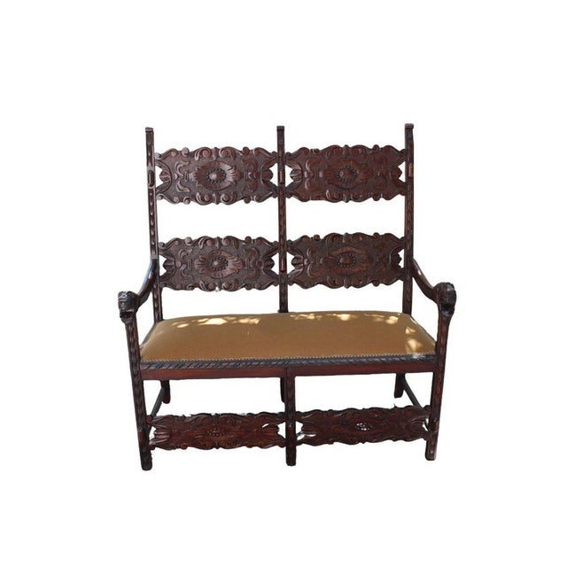 Rustic yet elegant antique Italian bench featuring richly carved solid wood and a beautifully upholstered seat. The...
