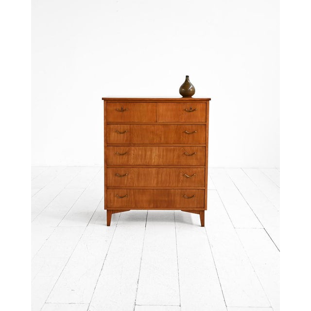 Five-drawer teak chest of drawers with brass handles and tapered legs. Scandinavian production, 1960s. Scandinavian chest...
