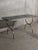 Modernist console table in brushed steel and smoked glass - 1970s in the style of Maria Pergay. This console table...