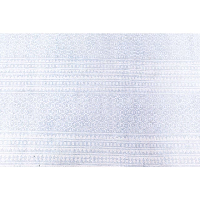 Softly whispering tales of refined tradition, this rare cotton Agra rug from the 1930s exudes a sense of understated...