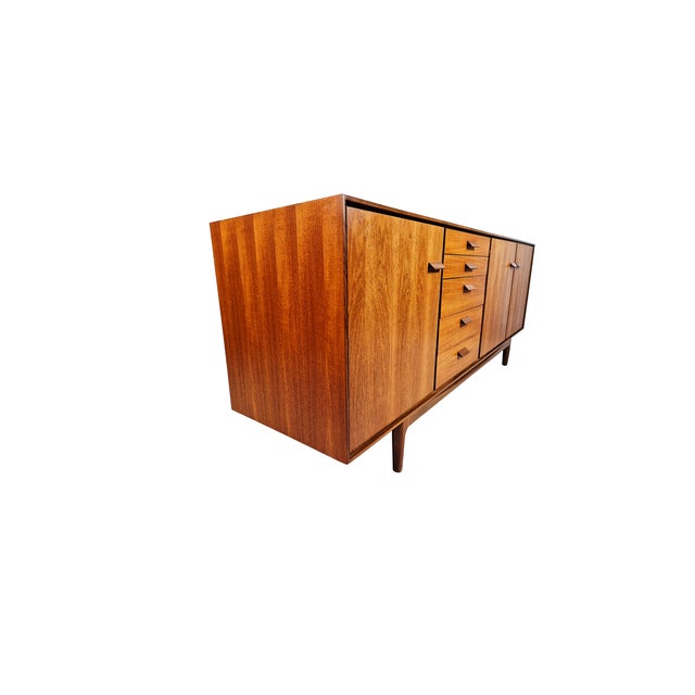 This Ib Køfod-Larsen sideboard is a standout example of Scandinavian modern design produced in collaboration with the...
