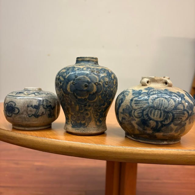 A curated trio of 19th-century blue and white stoneware jars from Vietnam. Each piece is hand-thrown and uniquely...
