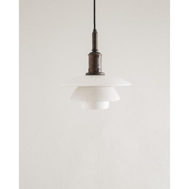 Rare and early danish mid century modern ceiling pendant lamp in white opaline glass shades with a beautifully patinated...