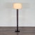 This modern floor lamp features a sturdy, textured dark wood brown base and a classic white drum shade. Its simple design...