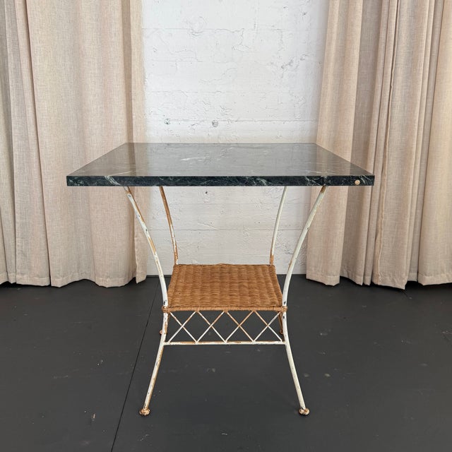 Lovely rustic, country, indoor or outdoor café, luncheon dining table features a nicely grained, deep green square marble...