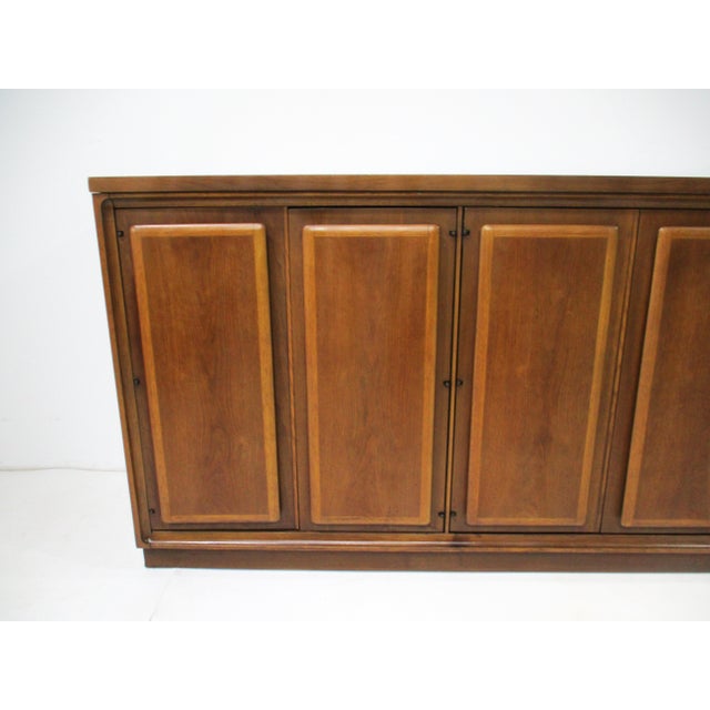 A very well- crafted walnut credenza / server with two doors and four drawers to the left side and to the right side three...