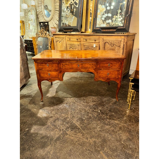 The 19th c. Italian Walnut Bureau Plat is a luxurious indoor furniture piece crafted from high-quality walnut. Made during...