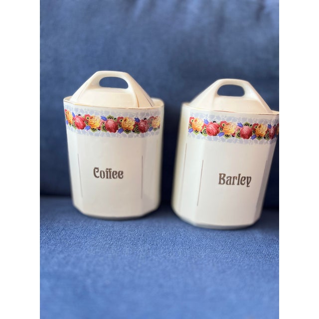 This vintage 1930s Canister Set from Germany features a beautiful floral rose design in shades of white and gold. The set...