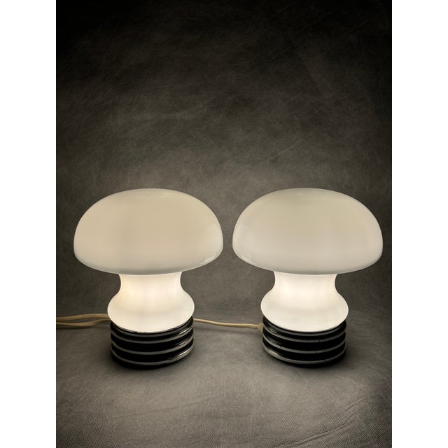 A pair of original Graewe mushroom night lamps from the 1970s, featuring black plastic bases and double-layered opal glass...