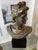 Neoclassic style bronze female bust. Mounted on a square black laminate-covered base.