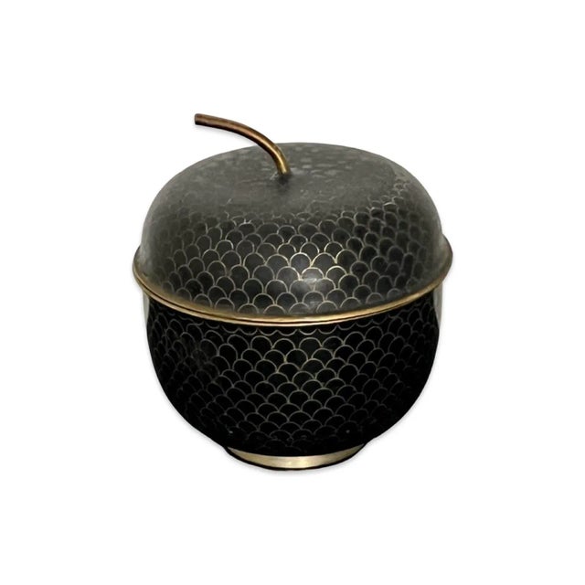 A striking vintage cloisonné lidded box crafted in the form of an acorn. This decorative object features a rich black...