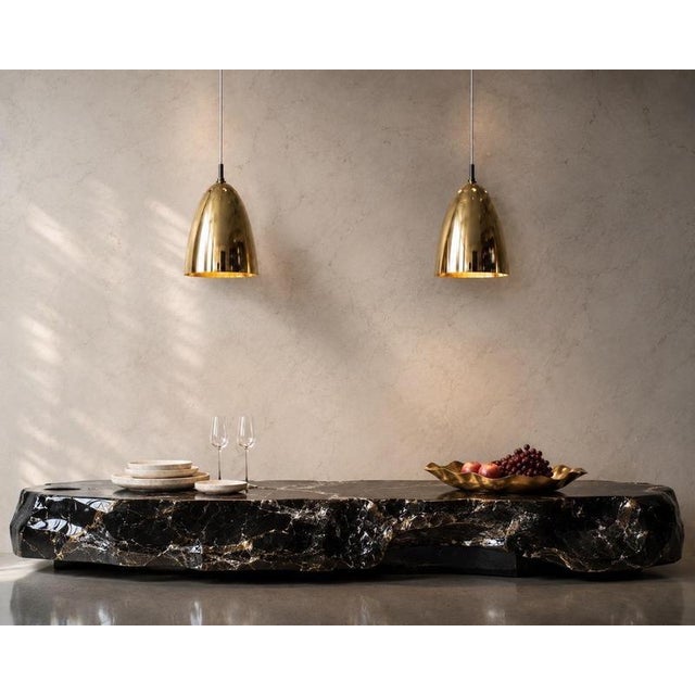 An extraordinary pair of authentic 1960s pendant lights, exceptionally crafted from solid brass, originating from a former...