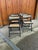 Set of five vintage folding chairs from the 1970s, featuring black wooden frames and handwoven cane seats and backs. The...