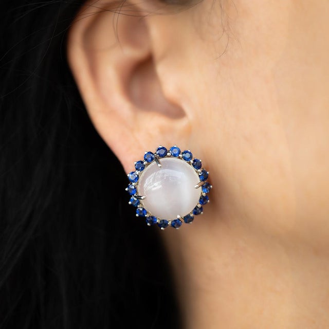 Oscar Heyman Platinum earrings with 2 cats eye moonstones weighing 41.49 carats and 36 round sapphires weighing 4.78...