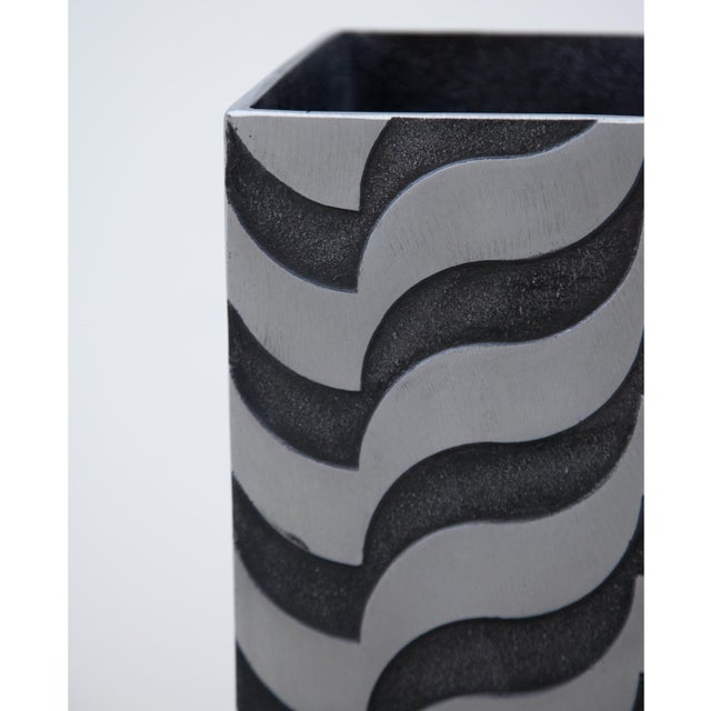 A sculptural modernist tall vase by artist Lorenzo Burchiellaro. Textured cast aluminum with wave pattern detail.