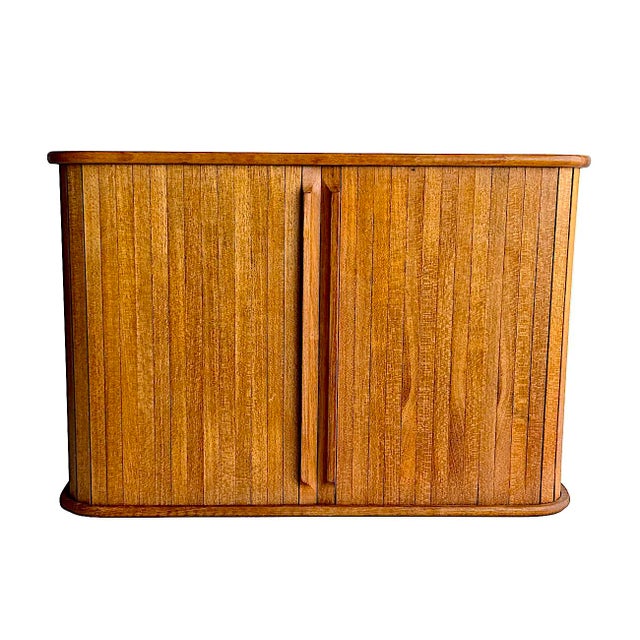 Offered is a mid 20th Century Teak wood tambour sliding door wall mounting shelf cabinet. This piece can be used for...