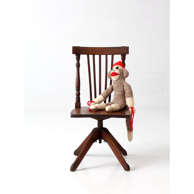 Antique Victorian children's swivel chair showcasing the remarkable craftsmanship and thoughtful design of its full-size...