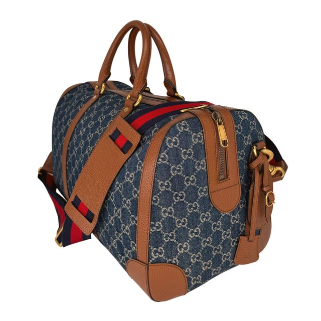 Gucci Denim GG Supreme Canvas and Brown Leather Duffle Bag, Spring/Summer 2022. The classic Gucci monogram canvas takes a...