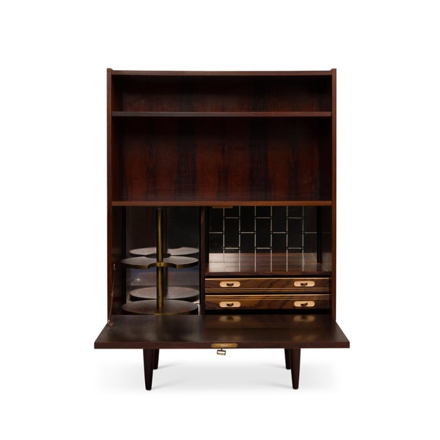 A truly distinctive piece, this vintage Danish Mid-Century Modern hutch/bar is sure to be a conversation starter. The...