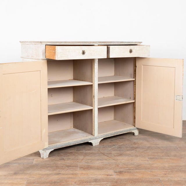 Early 19th century Swedish tall sideboard, crafted in pine and retaining its original painted finish. Fluted carved...