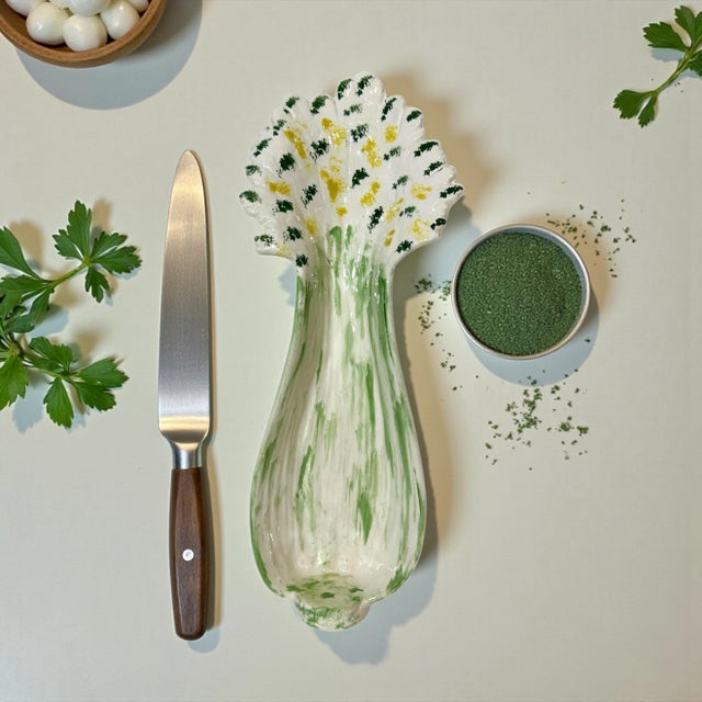 This ceramic serving dish dates from the 1970s. The celery stalk form with decorative floral elements is perfect for...