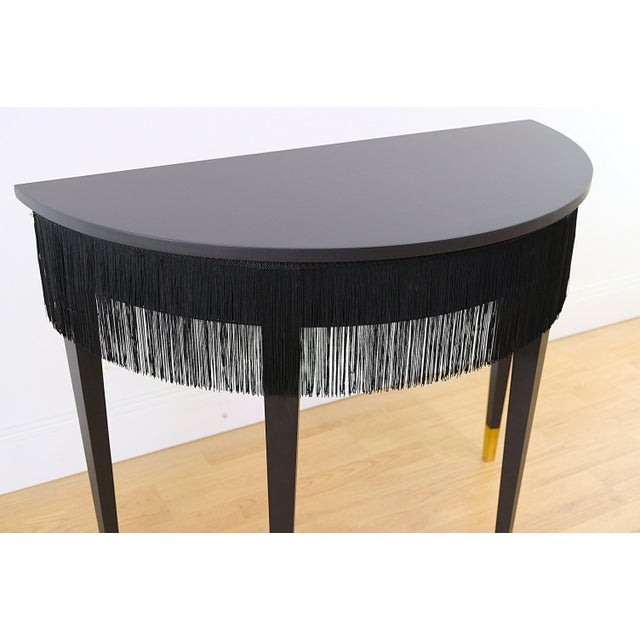 Classic Moon table / dressing table in a restored condition. Matte black and with fringes around the top. Gold leaf on...