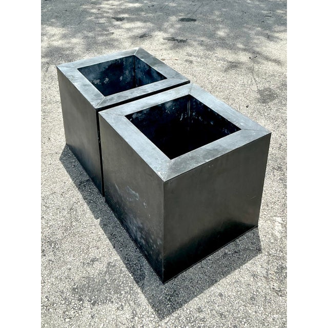 Elevate your indoor or outdoor oasis with this striking Pair of Vintage Industrial Patinated Square Tin Planters, a truly...