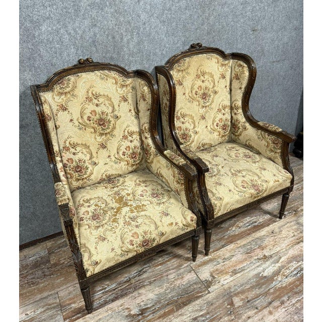 Large pair of Louis XVI-style wingback chairs in carved wood, circa 1850 Floral upholstery Fluted spindle legs Wide,...