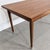 Vintage teak dining table dating from the 1960s/1970s, featuring a rectangular top and two sliding side extensions. The...