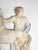A late 19th century French neoclassical plaster relief sculpture of a toga clad figure with horse in faded polychrome.