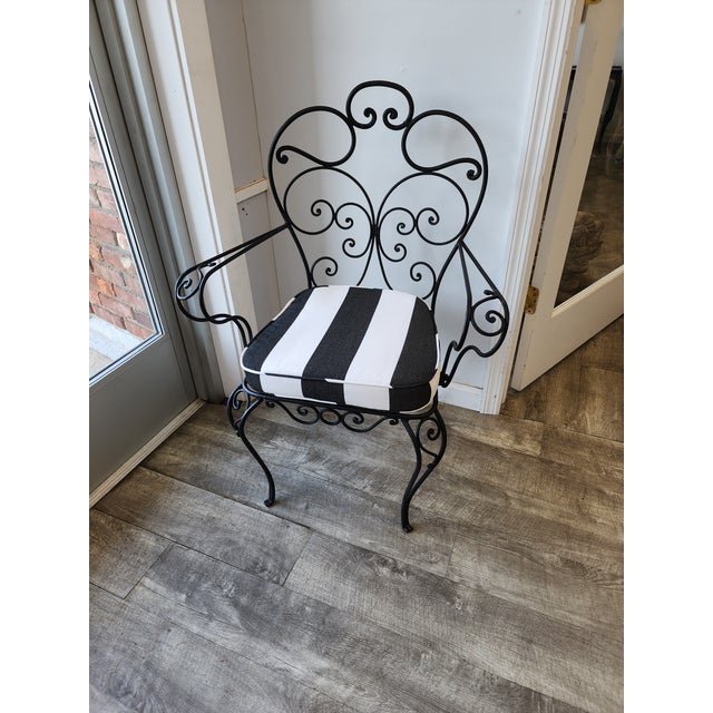 Add timeless style and European elegance to your space with this vintage masterfully crafted hand-wrought iron scroll-arm...