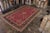 Hand knotted in wool originating from Turkey circa 1900-1910, this antique floral Gordes rug enjoys the marriage of an...