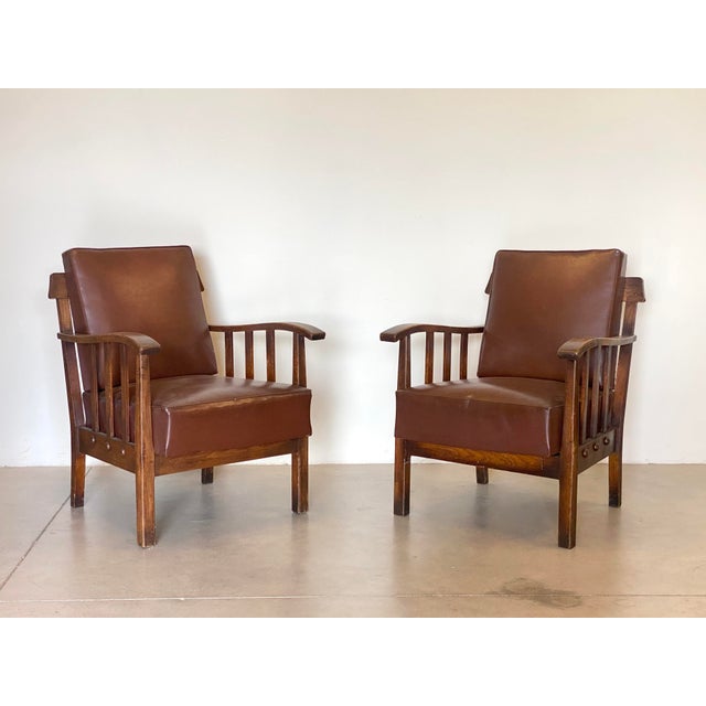 Pair of 1960s oak armchairs, imitation leather seat to be redone.