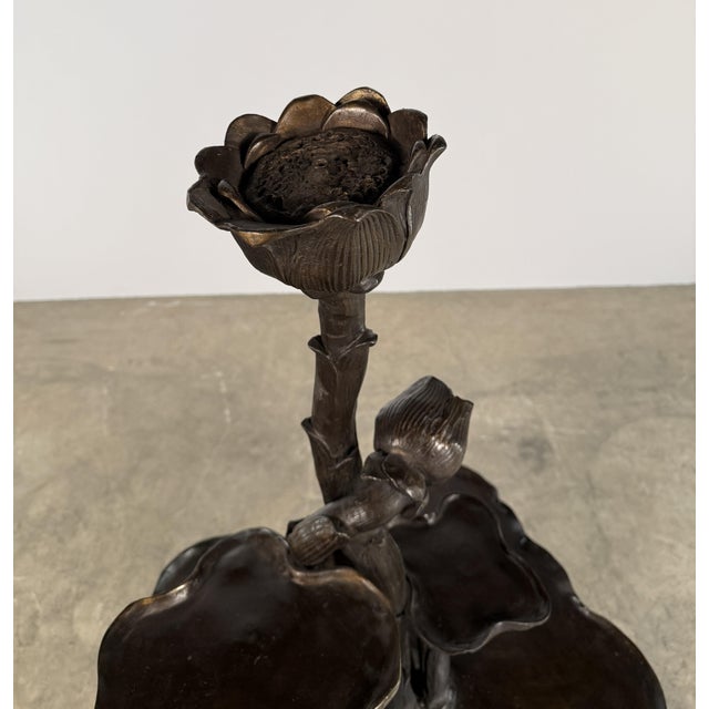 A striking monumental bronze fountain sculpted in the form of a blooming lotus plant, rising in layered tiers of organic...