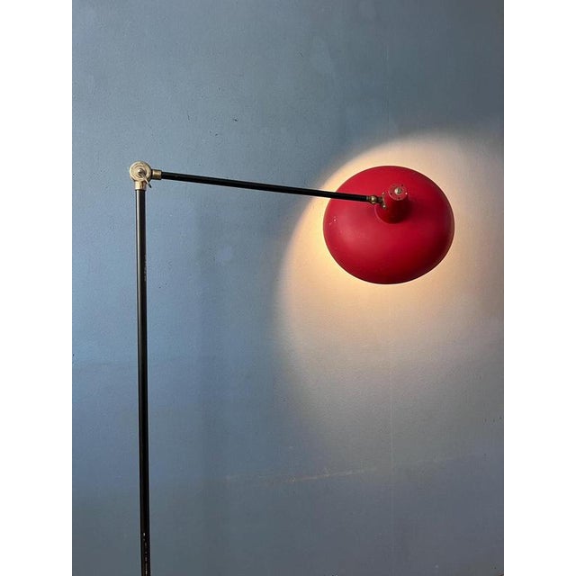 A beautiful vintage anvia floor lamp designed by dutch designer j.j.m. Hoogervorst. The lamp features a striking red metal...