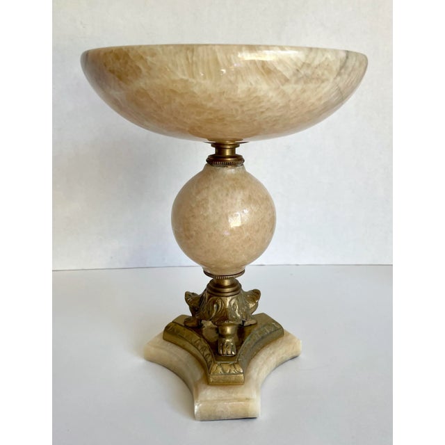 Here is a gorgeous marble alabaster display bowl with brass accents. As you can see, the base features a 3 legged detail...