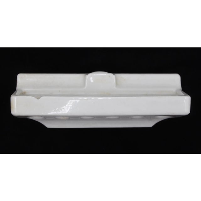 Vintage flush mount toothbrush holder made of white ceramic. It is compatible with six toothbrushes. Good condition with...