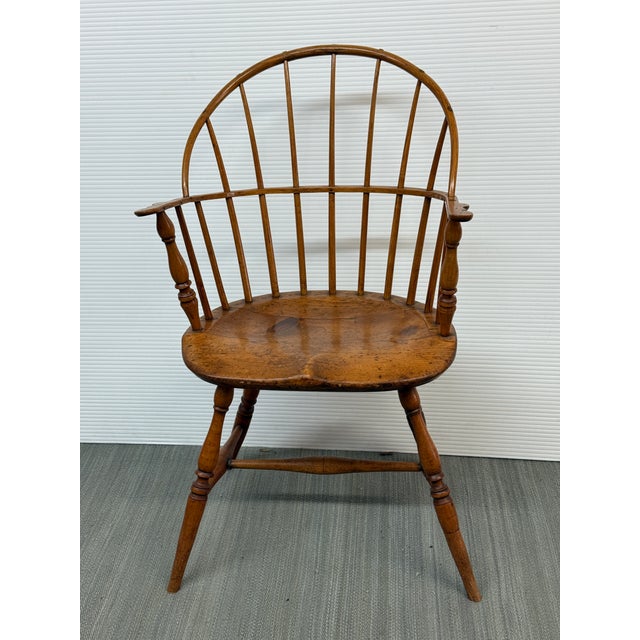 Design Plus Gallery presents a Lancaster Sack-Back Arm Chair from the Late 18th Century. The chair has a bowed crest rail...