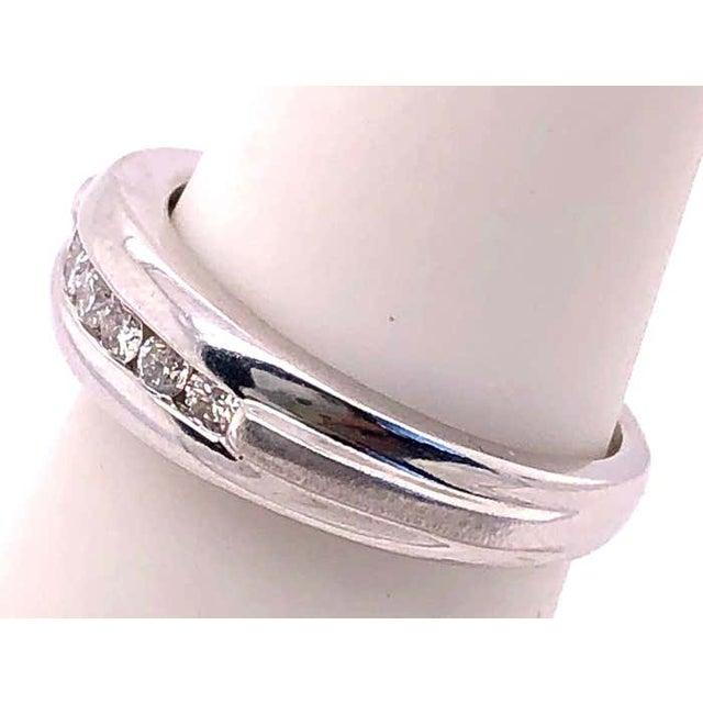 14 Karat White Gold And Diamond Wedding band 0.21 Total Diamond Weight. Size 4.75 2.76 grams total weight.