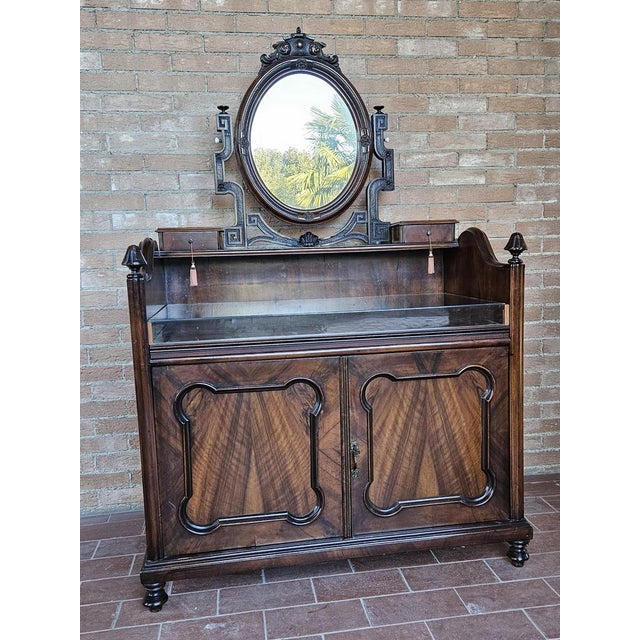 Sideboard by living room in mahogany wood with a double door in internal shelf and a pretty swivel sworn mirror in carved...